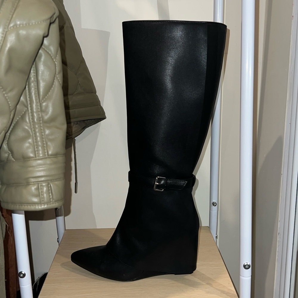Black pointed toe, heeled knee-high boots with silver buckle detail